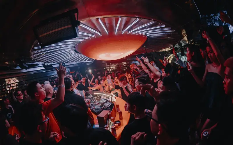 Glowing orange dome above the central DJ booth